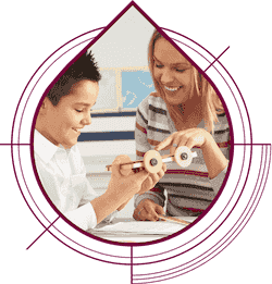 Boy making wooden car with teacher